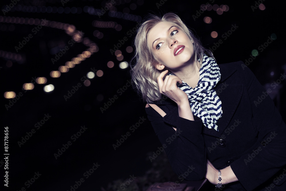 Young blond fashion woman on the night city street Young blond fashion woman on the night city street