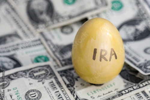 IRA retirement saving golden egg on cash photo