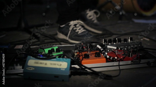 Close up of guitar players foot pressing pedal board