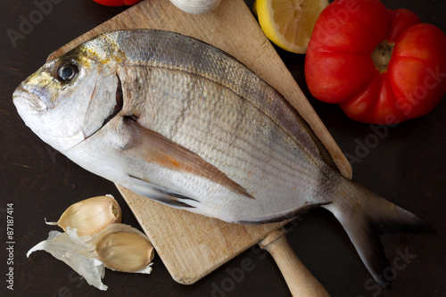 fresh sea bream fish (Sargo) on board, food close up photo