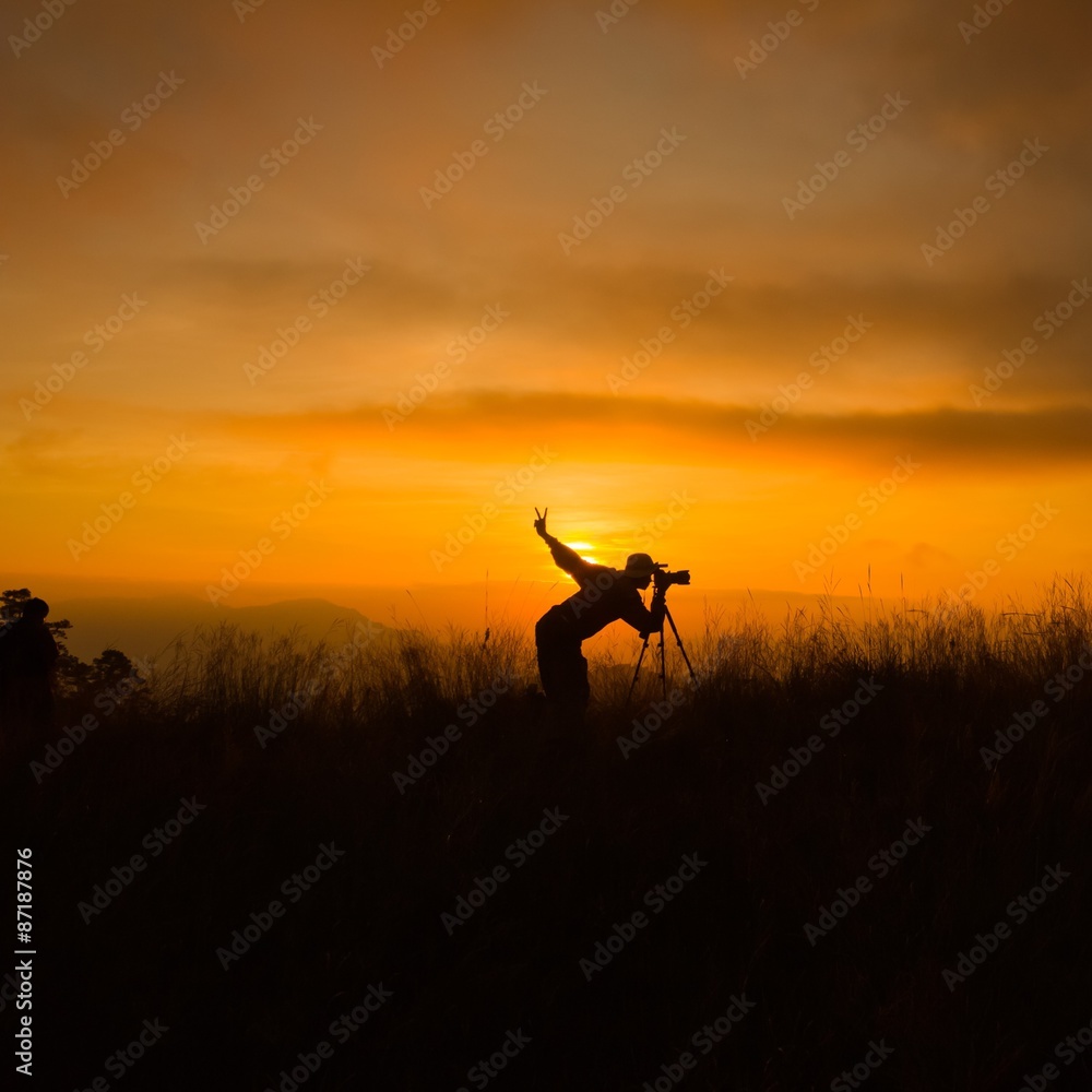 Silhouette of photography on the cliff Silhouette of photography on the cliff