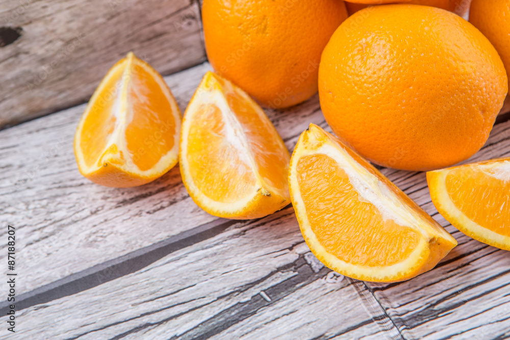 Fototapeta premium Orange fruits over weathered wooden background