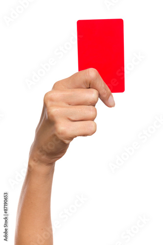 Close up of woman's hand holding penalty red card. Studio shot isolated on white.