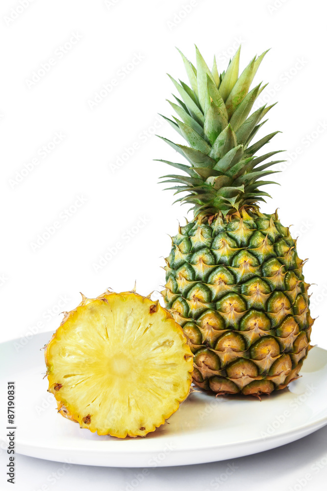Pineapple with slices on a white dish, Fruit. Pineapple with slices on a white dish, Fruit.