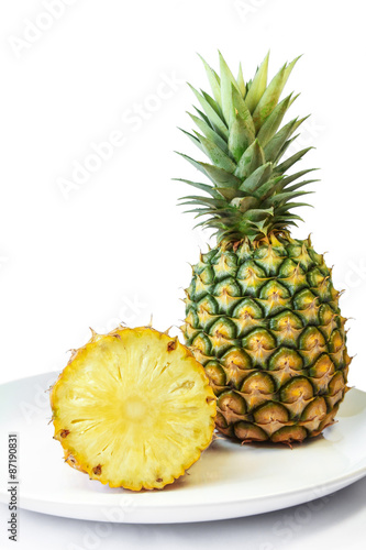 Pineapple with slices on a white dish, Fruit.
