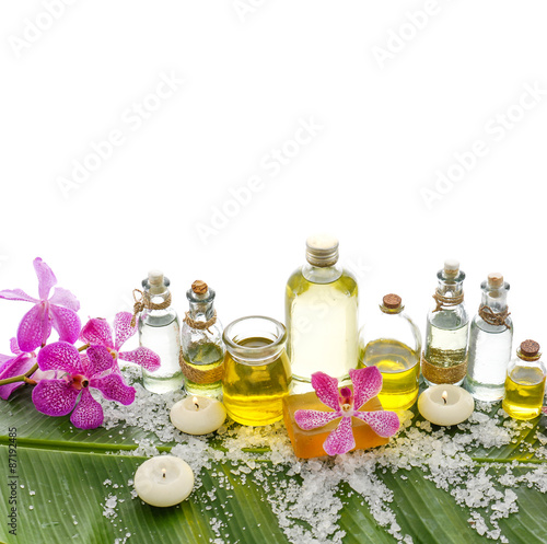 spa supplies with orchid oil  candle on banana leaf