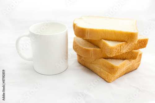 Empty coffee cup or coffee mug and sliced bread isolated on whit