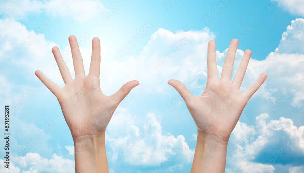 two woman hands making high five over blue sky two woman hands making high five over blue sky