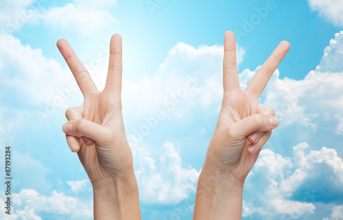 woman hands showing victory or peace sign