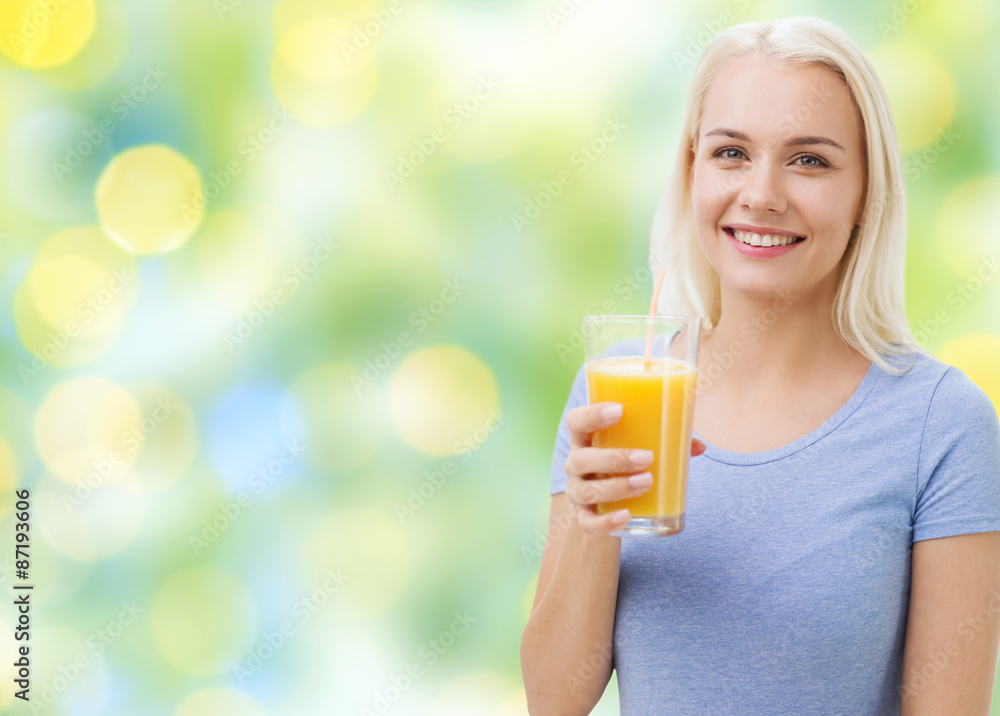 smiling woman drinking orange juice smiling woman drinking orange juice