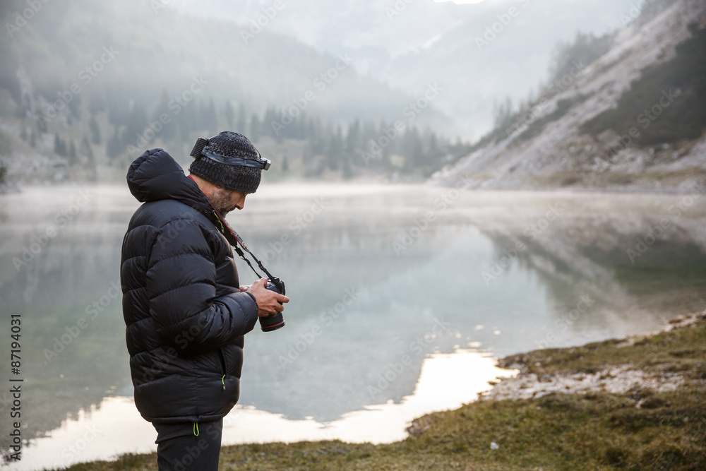 Photographer holding a camera, checking photos