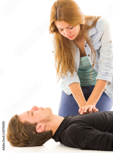 Couple demonstrating first aid techniques with woman applying cpr on male pattient lying down