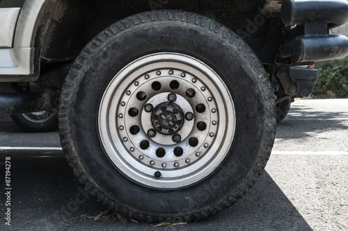 Off-road car wheel on steel disc, closeup photo
