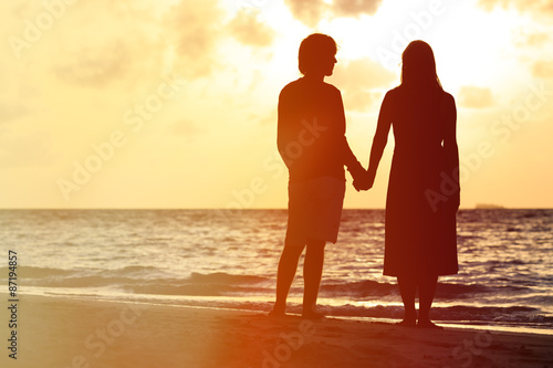 Romantic couple on the beach at sunset