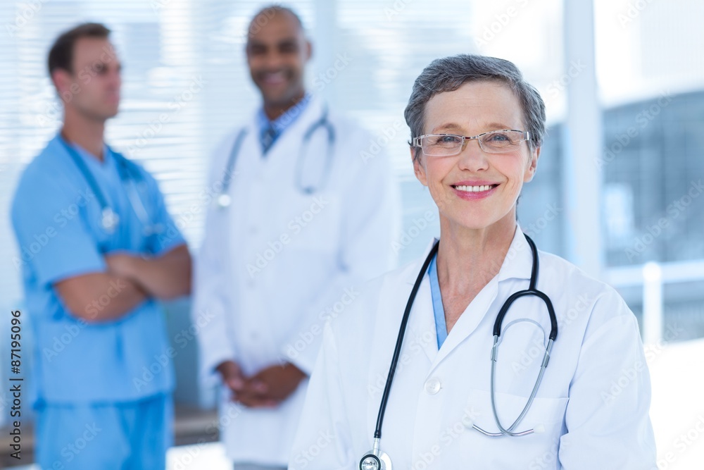 Smiling colleagues doctors looking at the camera Smiling colleagues doctors looking at the camera