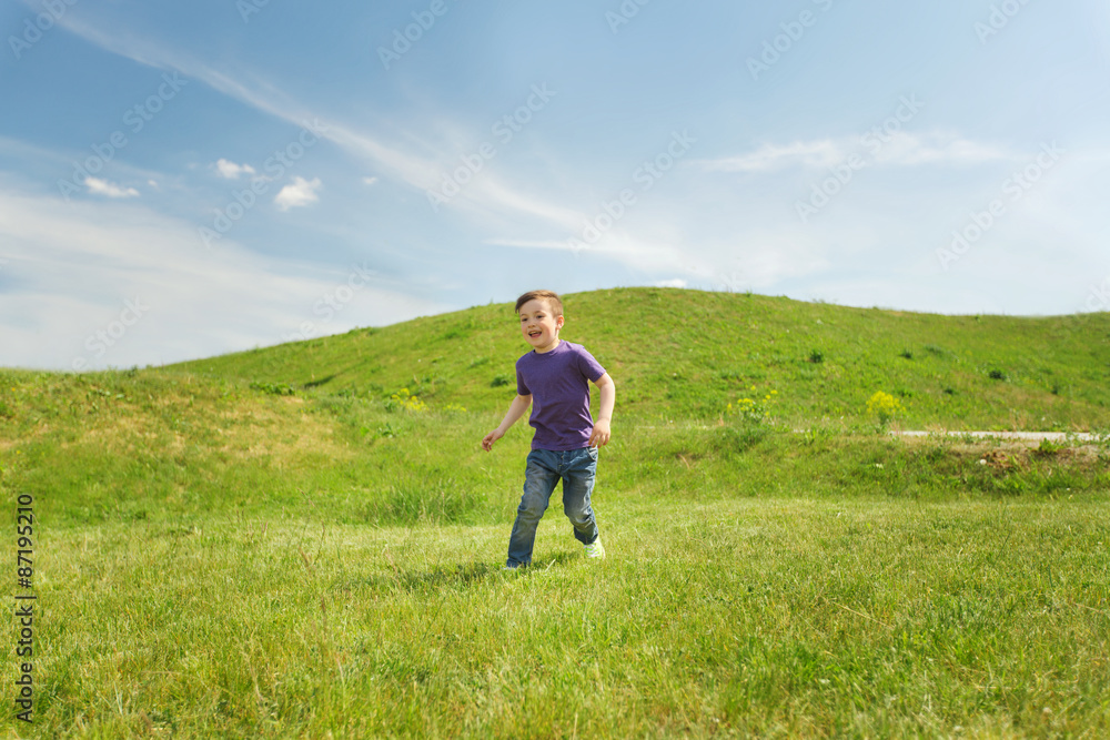 happy little boy running on green field outdoors happy little boy running on green field outdoors
