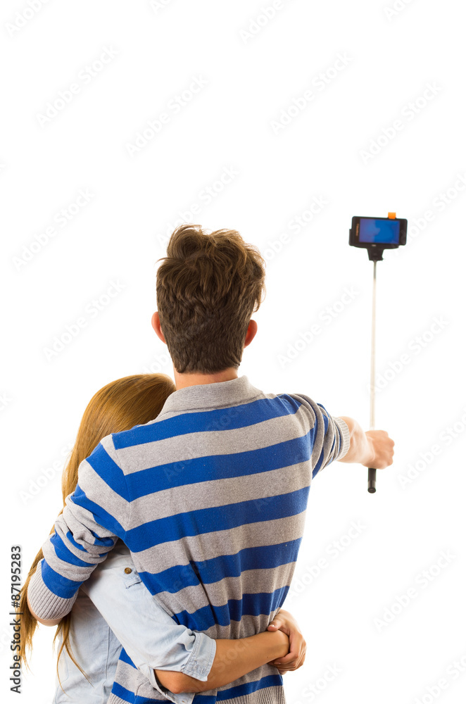 Couple with selfie stick posing for mobile back facing camera Couple with selfie stick posing for mobile back facing camera