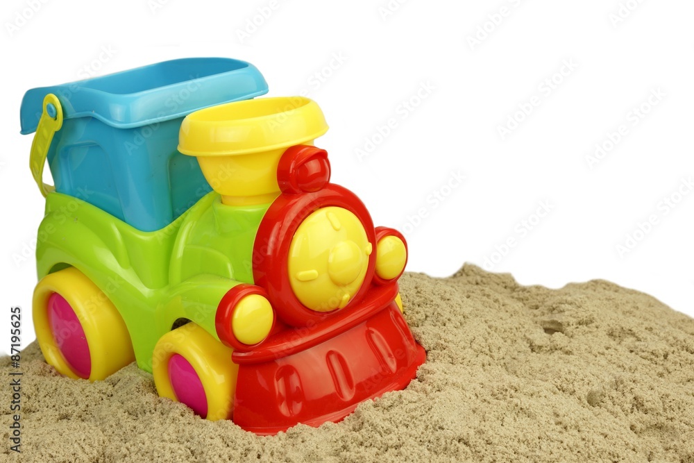 Close-up Of Toy Train With Sand Heap Isolated Close-up Of Toy Train With Sand Heap Isolated