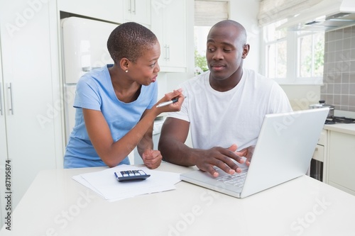 Happy couple working and using laptop