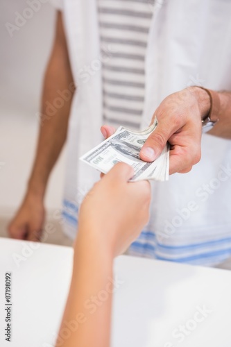 Customer giving cashier money
