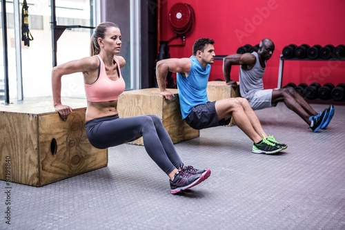 Three young Bodybuilders doing exercises