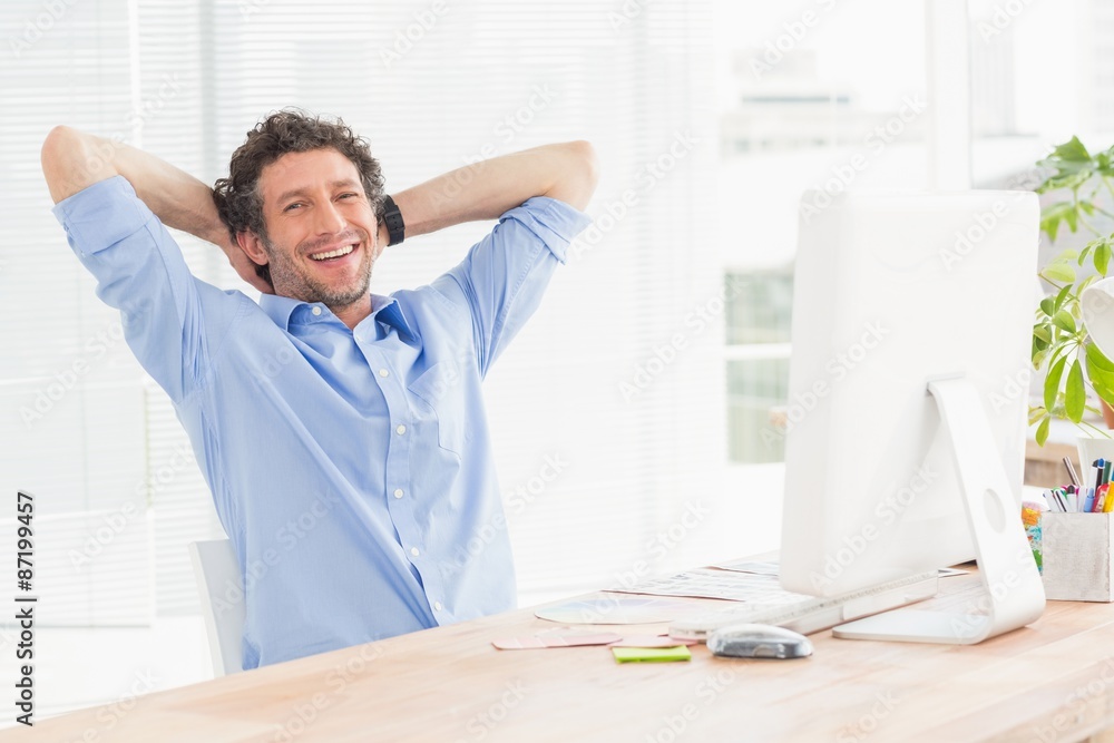 Casual businessman using computer in office Casual businessman using computer in office
