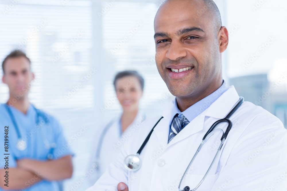 Smiling colleagues doctors looking at the camera Smiling colleagues doctors looking at the camera