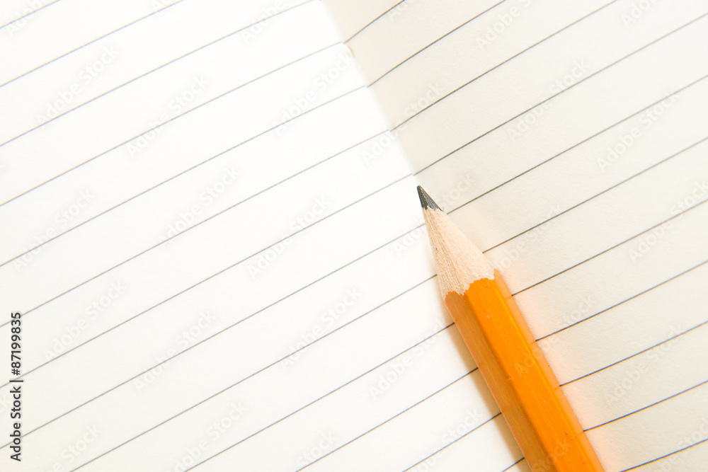 Opened notebook and pencil on the old tissue Opened notebook and pencil on the old tissue