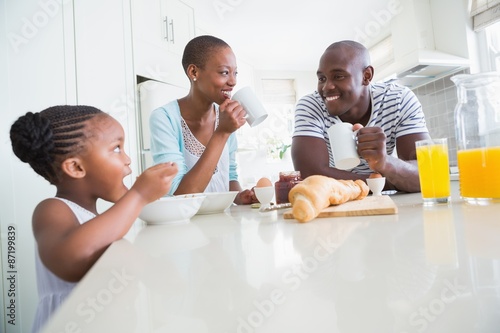 Happy family sitting and taking breakfast