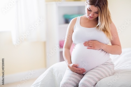 Free Download Pregnant woman looking at her belly  - GFXLoad