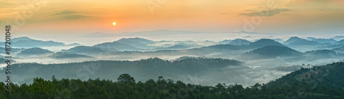 Sunrise over the panoramic mountains of Dalat with his sun rise on the hill waxing pine soon covered with clouds and fog do to honor the beauty highland Da Lat