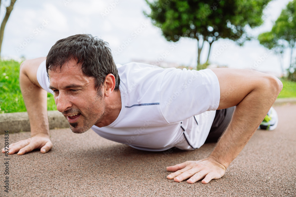 Man doing pushups outdoors