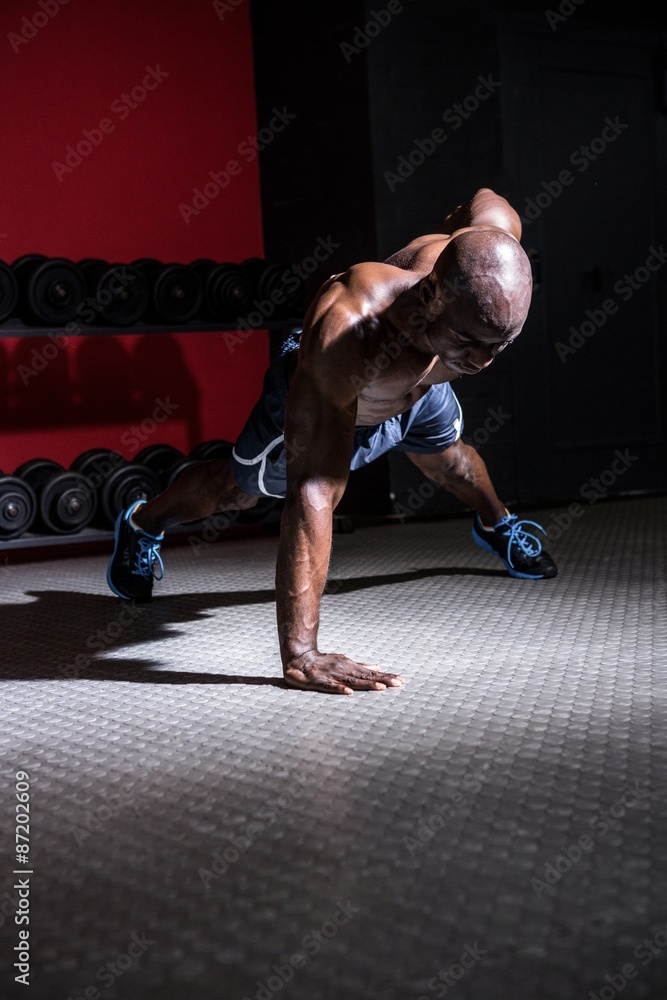Fototapeta premium Young Bodybuilder doing One-armed push ups