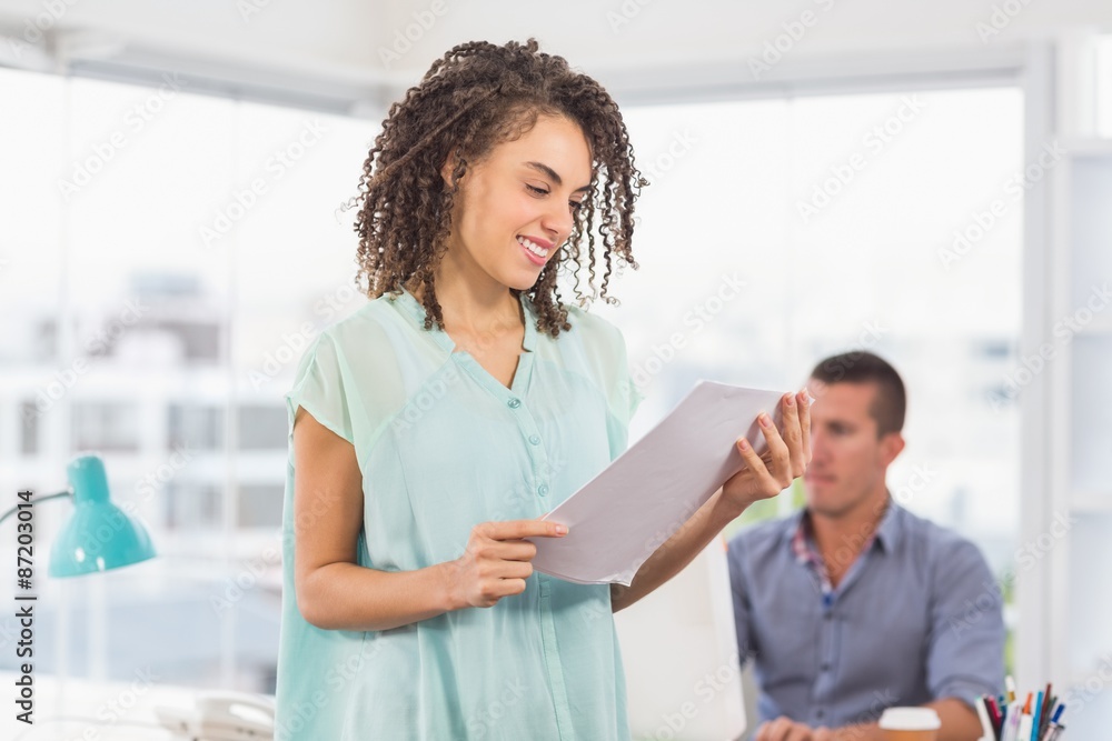 Smiling businesswoman reading a notebook