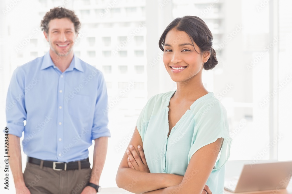 Casual business partners smiling at camera Casual business partners smiling at camera