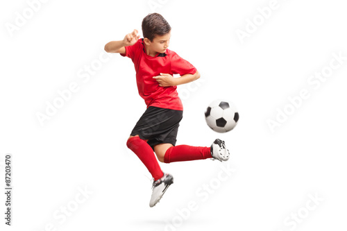 Slika na platnu Junior soccer player performing a trick