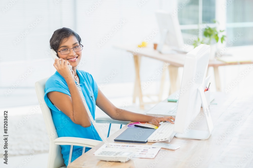 Casual designer working at her desk Casual designer working at her desk