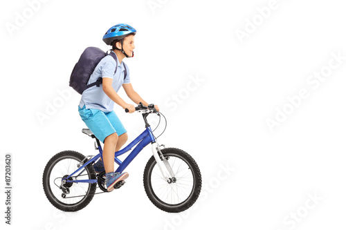 Schoolboy with a helmet riding a bike