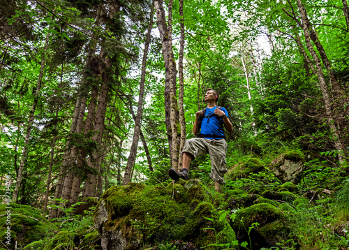 Active healthy man hiking in beautiful mountains forest