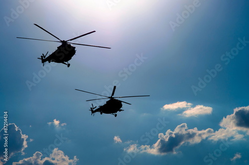Fototapeta Naklejka Na Ścianę i Meble -  silhouettes of two helicopters flying