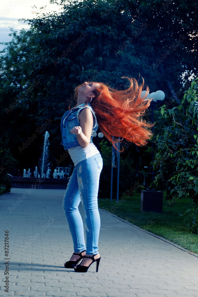 Naklejka premium Full length portrait of red haired women shaking her head. Long 