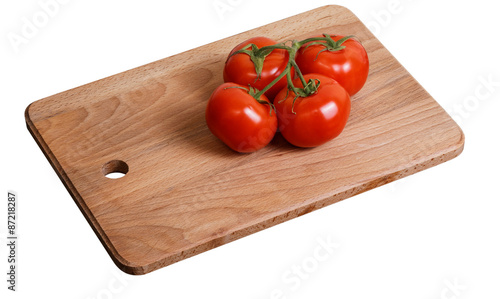 Branch of tomatoes on the kitchen cutting board
