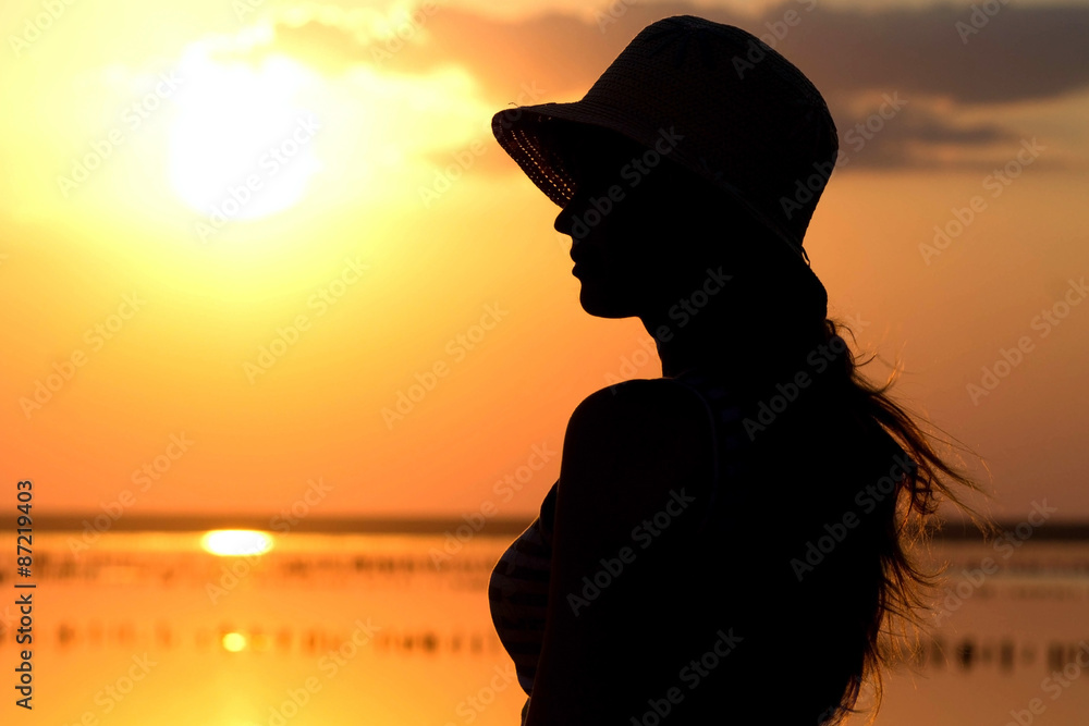 young girl at sunset on the sea