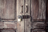 locked wooden door with metal padlock