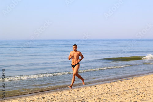 young man jogging on the beach