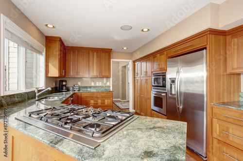wonderful kitchen with deep hardwood floor and marble counters.