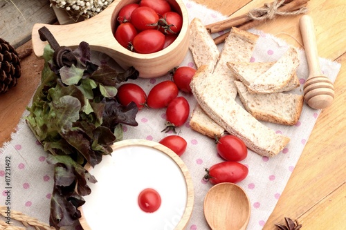 White yogurt and fresh cherry tomatoes