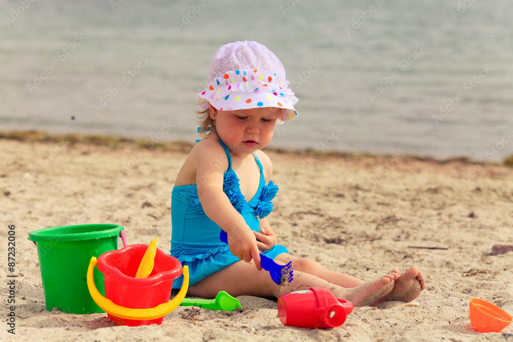 Child playing with toys at beach in summer Child playing with toys at beach in summer
