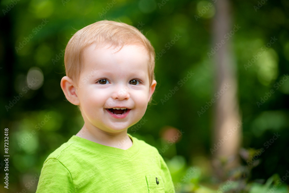 Portrait of happy smiling toddler playing outdoors Portrait of happy smiling toddler playing outdoors