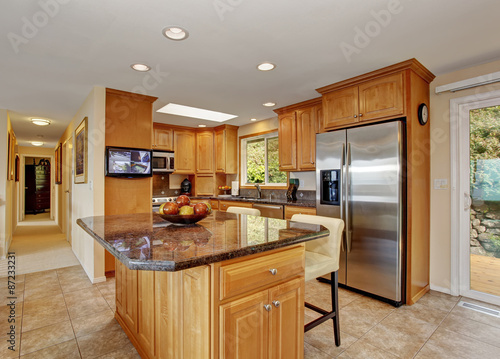 traditional kitchen with island and tile floor.